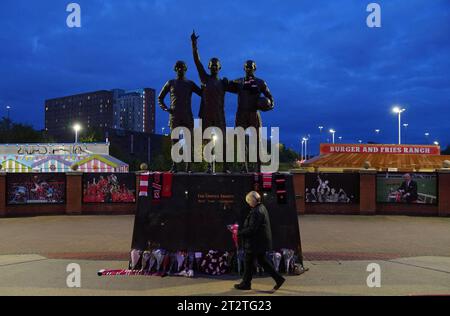 Tributes are laid in memory of Sir Bobby Charlton by The United Trinity statue at Old Trafford, Manchester. Sir Bobby Charlton has died aged 86, his family have announced. Issue date: Saturday October 21, 2023. Stock Photo