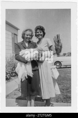 Vintage 1951 snapshot of mother and godmother at  daughter's christening, Missouri, United States Stock Photo