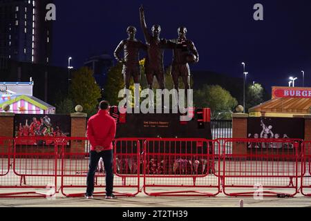 Tributes are laid in memory of Sir Bobby Charlton by The United Trinity statue at Old Trafford, Manchester. Sir Bobby Charlton has died aged 86, his family have announced. Issue date: Saturday October 21, 2023. Stock Photo