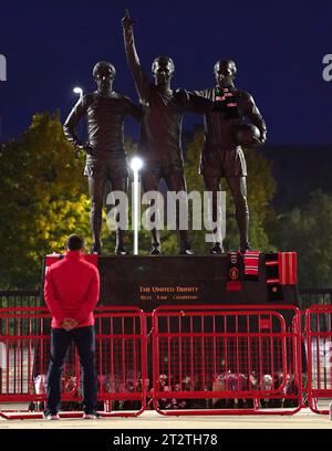 Tributes are laid in memory of Sir Bobby Charlton by The United Trinity statue at Old Trafford, Manchester. Sir Bobby Charlton has died aged 86, his family have announced. Issue date: Saturday October 21, 2023. Stock Photo