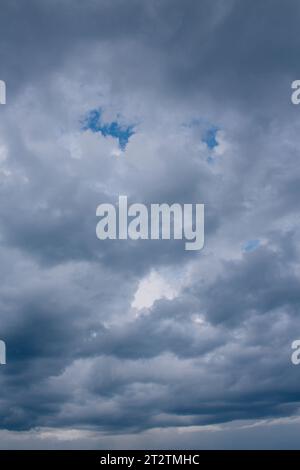 gloomy dark clouds with blue gaps of clear sky. sky light Stock Photo ...