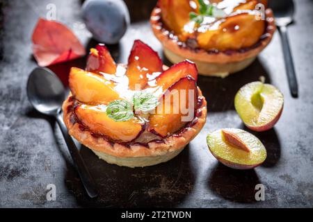 Tasty mini tart made of plums and cream. Cake with plums and cream. Stock Photo