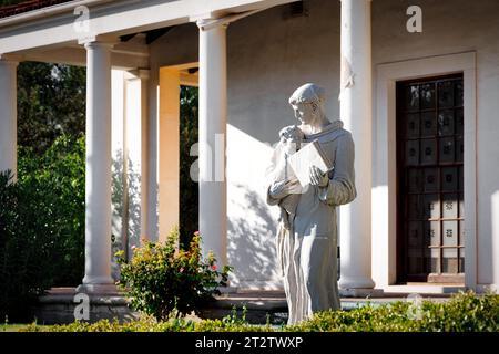 The late afternoon sun shines on a statue on the grounds of church in El Paso, Texas. Stock Photo