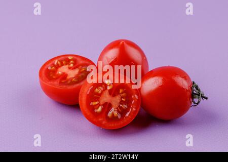 Cherry tomatoes on a pink background Stock Photo