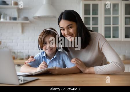 Head shot portrait Asian mother with son studying online Stock Photo