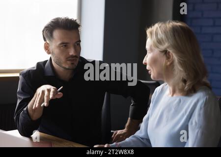 Two serious businesspeople work together in office Stock Photo