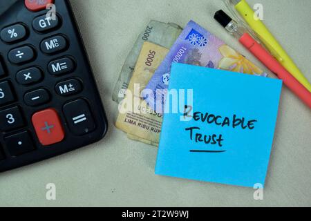 Concept of Revocable Trust write on sticky notes isolated on Wooden Table. Stock Photo