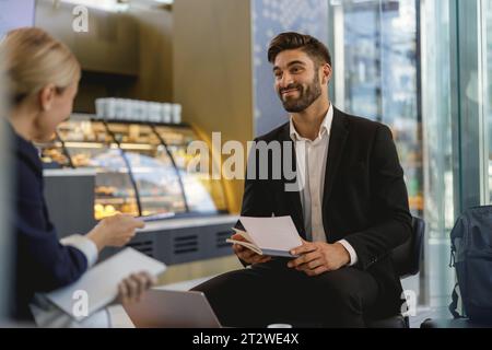 Two business colleagues have meeting in cafe to solve biz issues. Distance work concept Stock Photo