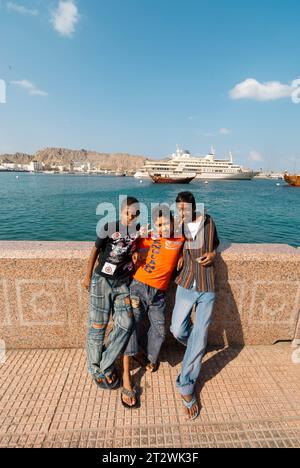 3 Local Young men pose for the camera in Mutrah Muscat in Oman Stock Photo