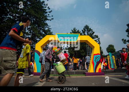 FIFA U-17 WOLRD CUP 2023 TROPHY EXPERIENCE People pass in front of a gate during the FIFA U-17 World Cup 2023 Trophy Experience in Bandung, West Java, Indonesia, October 22, 2023. The event was held to welcome the U-17 World Cup Football to be held in Indonesia on 10 November, 2023. Credit: Imago/Alamy Live News Stock Photo