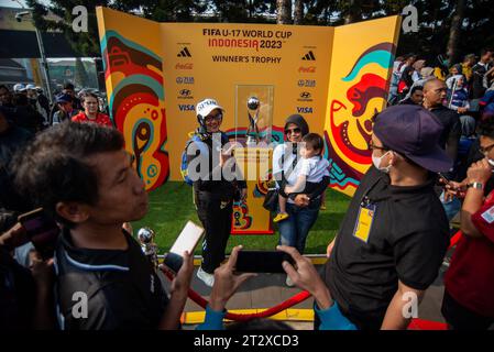 FIFA U-17 WOLRD CUP 2023 TROPHY EXPERIENCE People pass in front of a gate during the FIFA U-17 World Cup 2023 Trophy Experience in Bandung, West Java, Indonesia, October 22, 2023. The event was held to welcome the U-17 World Cup Football to be held in Indonesia on 10 November, 2023. Credit: Imago/Alamy Live News Stock Photo