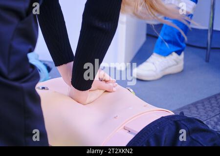 First aid training. Paramedic hand doing first aid to a mannequin patient Stock Photo