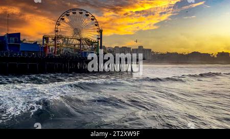 Waves crashing on the Santa Monica pier in the state of California in the United States of America, it is a highly visited place for its Ferris wheel Stock Photo