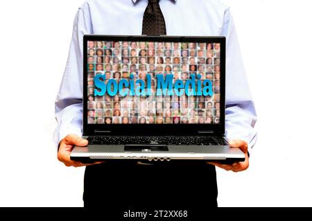 man in shirt and tie showing a laptop against white background Stock Photo