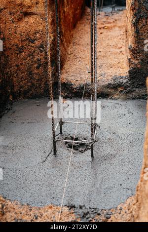 Wet Concrete or motrar mixing texture. Gray mortar, concrete surface. Foundation with steel rebar. Stock Photo