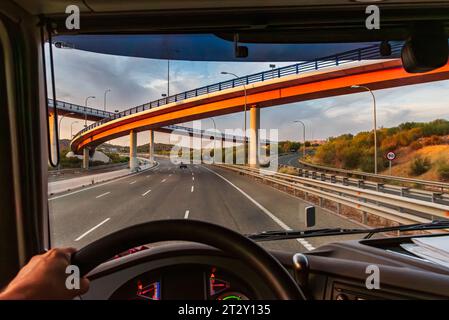 View from the driving position of a truck of a highway with several bridges at different levels. Stock Photo