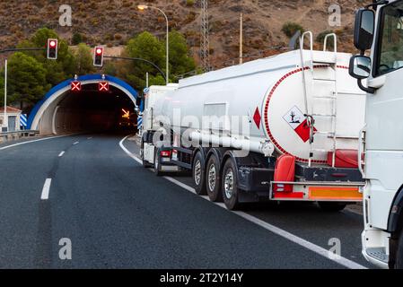 Trucks parked on the shoulder of a highway when the traffic lights and lights are red prohibiting passage. Stock Photo