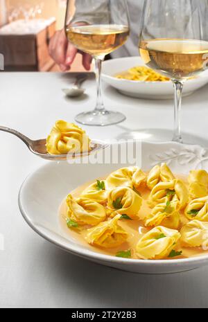 Tortellini in brodo, typical dish of the culinary tradition of northern regions of Italy. Stock Photo