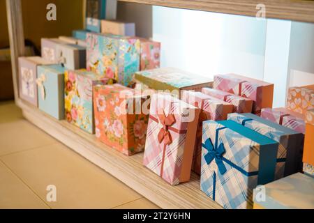 Gift box variety: vibrant colors and patterns neatly organized on tiered racks Stock Photo
