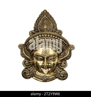 hindu goddess durga kali devi head sculpture carved with ornamental details crafted in golden brass isolated Stock Photo