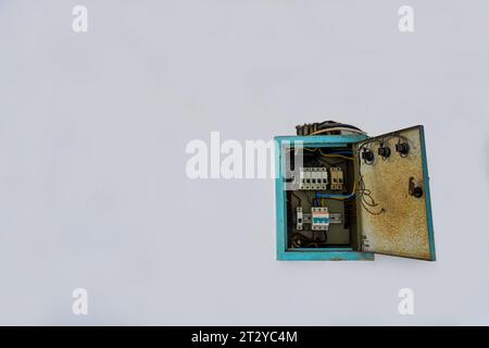 Power distribution board. Electrical panel with a row of fuses for different areas in a building, set against a white wall Stock Photo