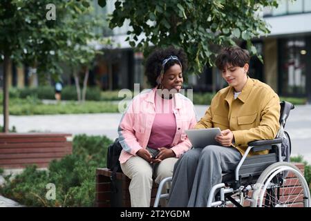 Multiethnic couple using tablet pc together during their walk in the city Stock Photo