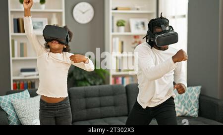 African american father and daughter playing video game using virtual reality glasses at home Stock Photo