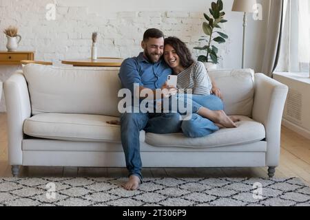 Joyful happy dating couple in love relaxing on home couch Stock Photo