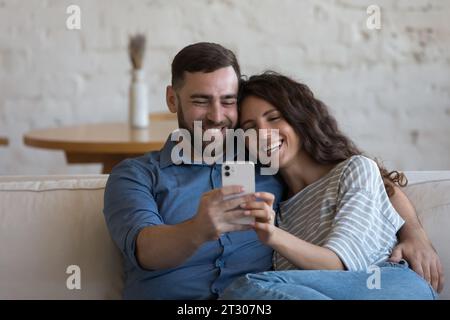 Happy millennial dating couple in love taking home selfie Stock Photo