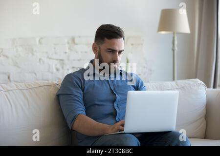 Focused laptop user freelancer man working from home Stock Photo