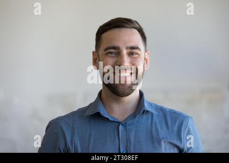 Happy man in casual blue shirt looking at camera Stock Photo