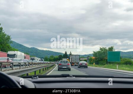 Driving on a highway through a picturesque landscape in - view from a car windshield Stock Photo
