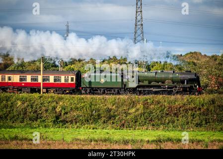 The Royal Scot heritage steam engine hauling the Pennine Moors Explorer rail tour on the West coast Main Line. Seen here at speed passing north throug Stock Photo