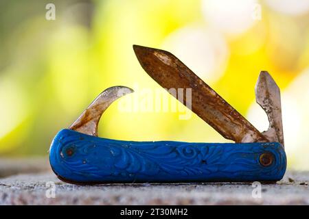 Swiss knife, used, dirty, pictured in nature. Stock Photo