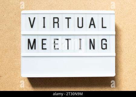 Lightbox with word virtual meeting on wood background Stock Photo