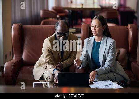 Business couple working online on laptop during their meeting in the hotel Stock Photo