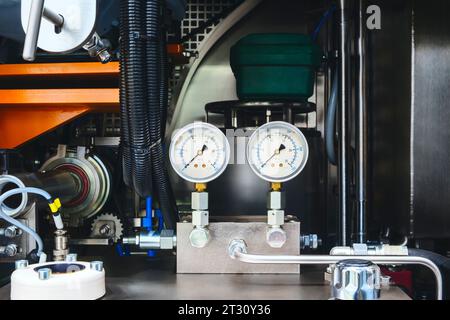air conditioner technician using manifold gauge checking refrigerant for filling home air conditioning and air duct cleaning and maintenance outdoor c Stock Photo