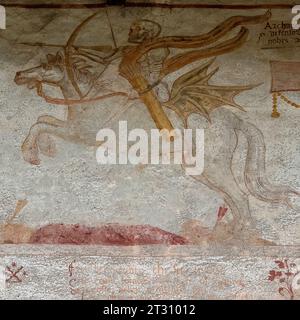 Death advances on horseback.  Detail from Renaissance Danza Macabra (Dance of Death) fresco frieze, painted in 1539 by Simone II Baschenis (c. 1495-1555) on an outside wall of the Chiesa di San Vigilio (Church of Saint Vigil or Vigilius), Pinzolo, Trentino-Alto Adige, Italy.  The frieze has captions in local dialects and language understood by ordinary people. Stock Photo