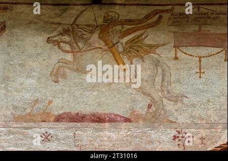 Death with bow and arrow on galloping stallion.  Detail from Renaissance Danza Macabra (Dance of Death) fresco frieze, painted in 1539 by Simone II Baschenis (c. 1495-1555) on an outside wall of the Chiesa di San Vigilio (Church of Saint Vigil or Vigilius), Pinzolo, Trentino-Alto Adige, Italy. Stock Photo