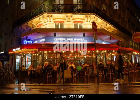 A night shot of the outside of creperie Saint Honore , French street food stall serving savoury and sweet crepes, which are similar to pancakes. Paris Stock Photo