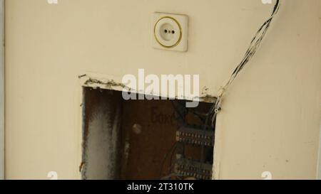 Old electric shield in wall of old house. Stock footage. Wires with bill and outlet in wall of old house. Electrical system of old village house Stock Photo