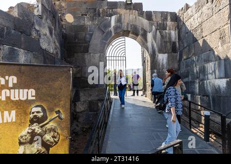 Garni, Armenia - September 30, 2023: tourists near gate to entrance to Garni Temple museum area in Armenia on autumn day Stock Photo