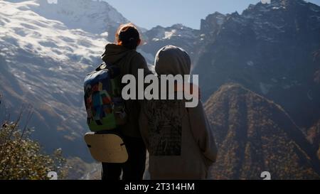 Family hikers exploring mountains on a sunny day. Creative. Concept of active lifestyle. Stock Photo