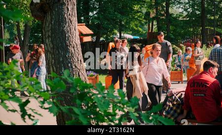 Manhattan, New York - September 19, 2022: People walk and relax in a city park. Clip. Green vegetation and families in a city park. Stock Photo