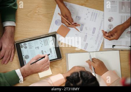 Hands of business people working with reports analyzing marketing reports Stock Photo