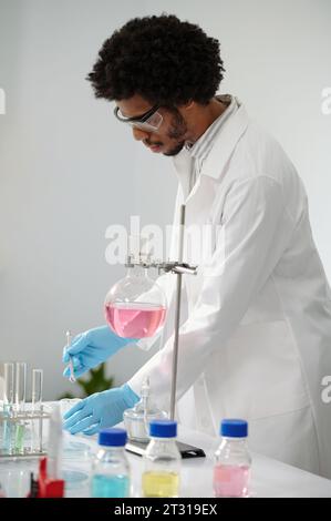 Chemical laboratory technician mixing reagents when working on medical solution Stock Photo
