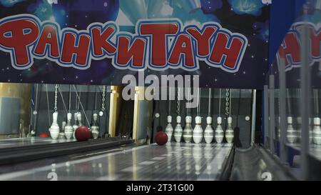 Serbia, Belgrade - June 20, 2023: Bowling lanes with balls and pins. Clip. Fun bowling with hanging pins. New bowling alley with balls and pins on Stock Photo