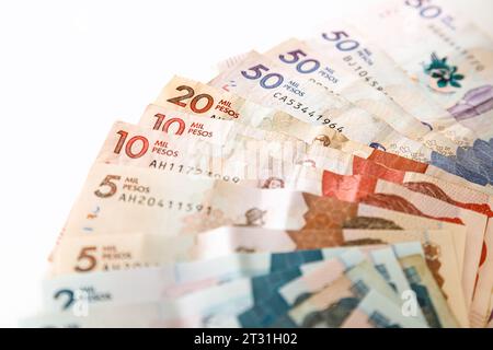 Macro closeup of Colombian pesos of different value in the shape of a fan on a white background Stock Photo