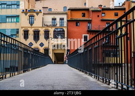 Gerona, Spain -- May 31, 2023. A photo of a teen sitting on the railing of the Gomez Bridge in Gerona. Stock Photo