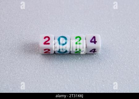 Year 2024, cubes with numbers on white glitter background Stock Photo